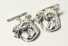 A PAIR OF SILVER HORSES HEAD CUFFLINKS.