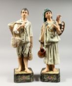 A PAIR OF 19TH CENTURY MAJOLICA GLAZED POTTERY FIGURES of a boy and girl water carrier. 13.5ins