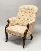 A 19TH CENTURY MAHOGANY FRAMED BUTTON UPHOLSTERED ARMCHAIR, with carved 