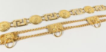 TWO GILT BELTS, both with five lion masks.