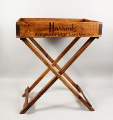 A HARRODS TRAY on a stand.