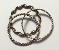 THREE ISLAMIC SILVER METAL BANGLES.