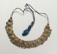AN ISLAMIC SILVER METAL NECKLACE.