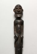A TRIBAL CARVED WOOD SCEPTRE, with figural top. 19.75ins long.