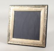 A SQUARE PHOTOGRAPH FRAME with crossbanded border. 6.5ins x 6.5ins.
