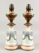 A PAIR OF LATE 19TH CENTURY PORCELAIN OIL LAMPS, with floral painted decoration and ormolu mounts.