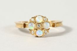 A 9CT GOLD, DIAMOND AND OPAL CLUSTER RING.