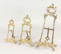 THREE VARIOUS BRASS EASELS.