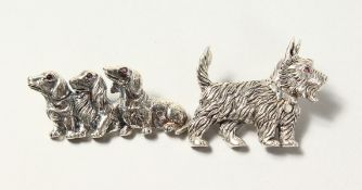 TWO SILVER AND RUBY DOG BROOCHES, SCOTTISH TERRIER AND THREE DACHSHUNDS. (2)