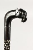 A CEYLONESE EBONY WALKING STICK, with carved elephant head handle and bone inlay. 37.5ins long.