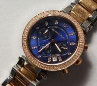 A GENTLEMAN'S MICHAEL KORS WRISTWATCH with three dials.