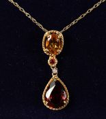 A 9CT GOLD, CITRINE AND GARNET PENDANT AND CHAIN.