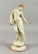 A ROYAL WORCESTER DANCING FIGURE OF A GIRL carrying a pitcher, on a circular base. 16ins high.