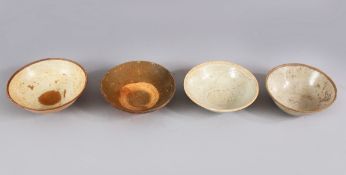 A LOT OF FOUR EARLY CHINESE POTTERY BOWLS, some glazed some unglazed. largest: 16cm diameter.