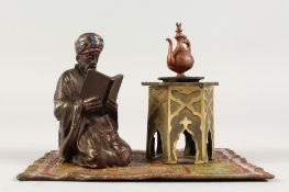 A VIENNA COLD CAST PAINTED BRONZE ARAB on a carpet with table and coffee pot. 5.5ins.