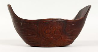 A CARVED WOOD FOOD BOWL, possibly Maori. 9ins long.