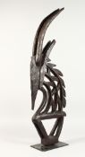 A BAMBARA TRIBE CARVED WOOD FIGURAL HEADDRESS, on a later stand. 33.5ins high.