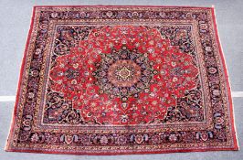 A PERSIAN CARPET, 20TH CENTURY, claret ground with allover stylised floral decoration. 11ft 4ins