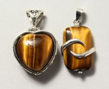 TWO SILVER AND TIGER'S EYE PENDANTS.