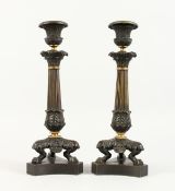 A PAIR OF LATE 19TH CENTURY BRONZE CANDLESTICKS of classical form, on three curving legs with