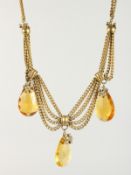 TWO TOPAZ PENDANTS on chain.