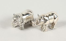 TWO CAST SILVER HIPPO AND RHINO FIGURES.