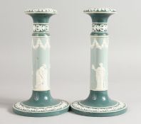 A PAIR OF CARLTON WARE JASPER CIRCULAR CANDLESTICKS on circular bases. Printed mark. 7.5ins high.