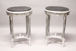 A PAIR OF OVAL SILVERED WOOD TABLES with marble tops.