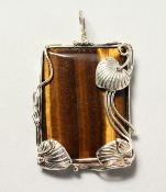 A SILVER AND TIGER'S EYE PENDANT.