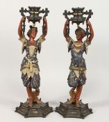 A PAIR OF SPELTER FIGURAL CANDLESTICKS, 20TH CENTURY, modelled as a Turkish man and woman holding