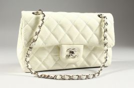 A CHANEL SOFT WHITE PADDED BAG with chrome and leather handles. 9.5ins wide, in a black Chanel bag.
