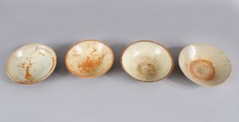 A LOT OF FOUR EARLY CHINESE POTTERY BOWLS, some glazed some unglazed. largest 16cm diameter.