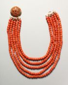 A SUPERB FIVE-ROW OF CORAL BEADS with gold clasp.