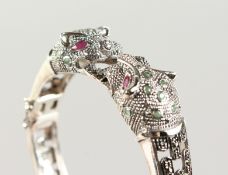 A SILVER, RUBY AND EMERALD PANTHER BRACELET.
