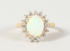 AN 18CT YELLOW GOLD, OPAL AND DIAMOND CLUSTER RING.