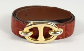 A BROWN LEATHER AND GILT BELT. 36ins long.