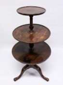 A GEORGE III MAHOGANY THREE-TIER DUMB WAITER, with central turned support, tripod base ending in pad