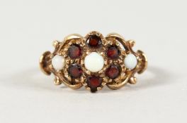 A 9CT YELLOW GOLD, REDSTONE AND OPAL RING.