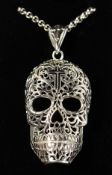 A LARGE SILVER CALAVERA SKULL PENDANT on a silver chain.