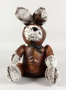 A LEATHER RABBIT DOORSTOP.