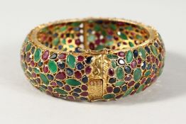 A SUPERB 18CT GOLD, EMERALD, RUBY AND SAPPHIRE BANGLE. 54gms.