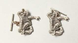 A PAIR OF MICHELIN MEN SILVER CUFFLINKS.
