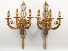 A PAR OF CAST METAL THREE LIGHT CLASSICAL STYLE WALL APPLIQUES. 27.5ins high.