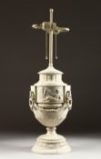 A BISQUE CLASSICAL URN LAMP on a circular base. 20ins high.