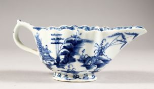 A WORCESTER BLUE AND WHITE RIBBED SAUCEBOAT, Buildings and Trees. 6ins long.