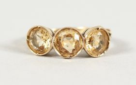 A 9CT YELLOW GOLD THREE-STONE TOURMALINE RING.