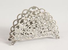A PIERCED FAN SHAPED SILVER LETTER RACK.