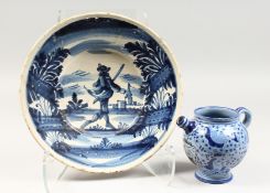 A 19TH CENTURY CONTINENTAL TINGLAZE CIRCULAR DISH, painted with a figure in a landscape, and a small