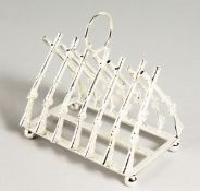 A SILVER PLATED CROSS GUNS TOAST RACK.