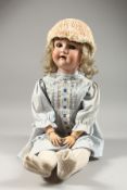 A LATE 19TH CENTURY/EARLY 20TH CENTURY PORCELAIN HEADED DOLL. 28ins high.